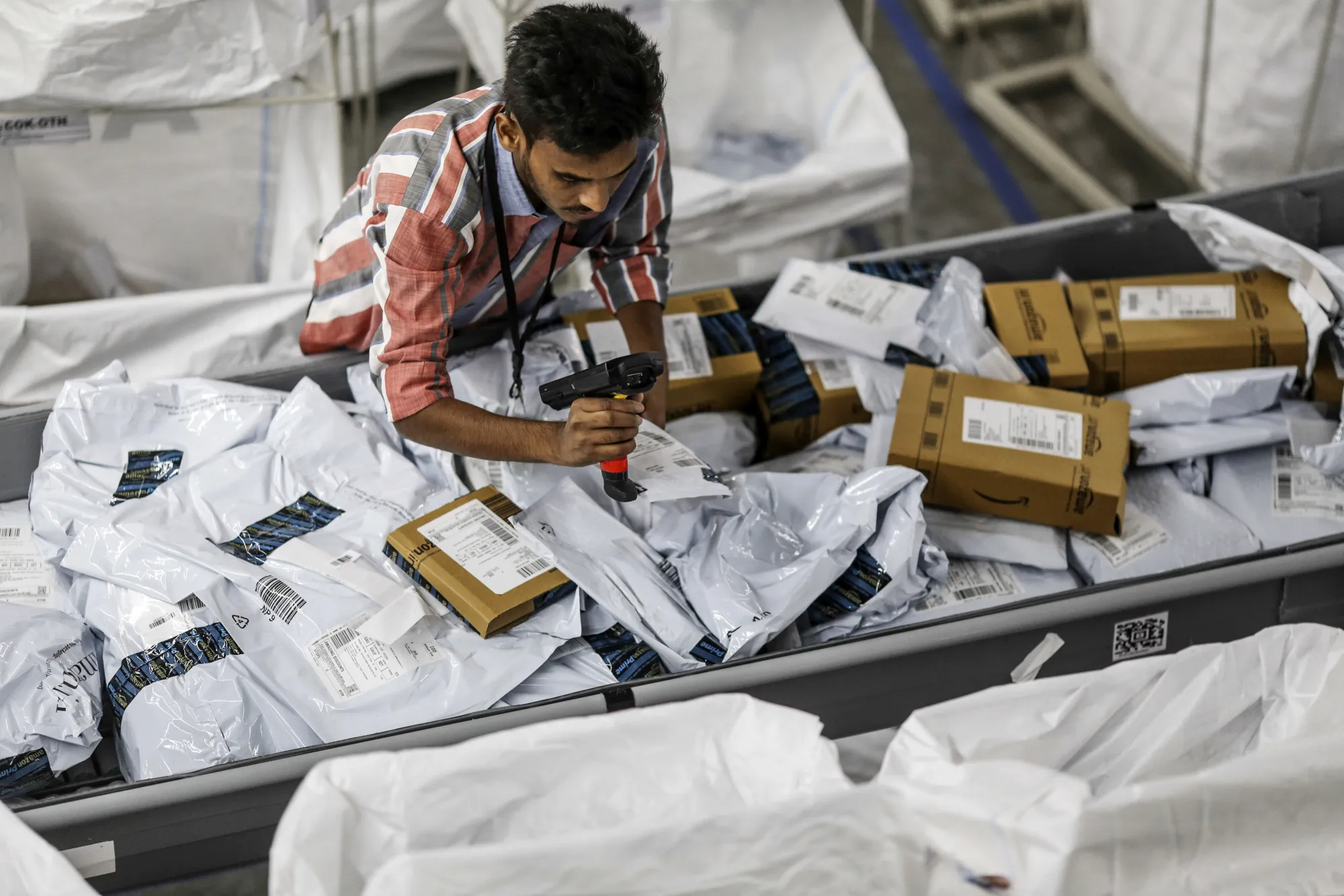An employee scans a package at the Amazon.com Inc fulfillment center in Hyderabad, India.