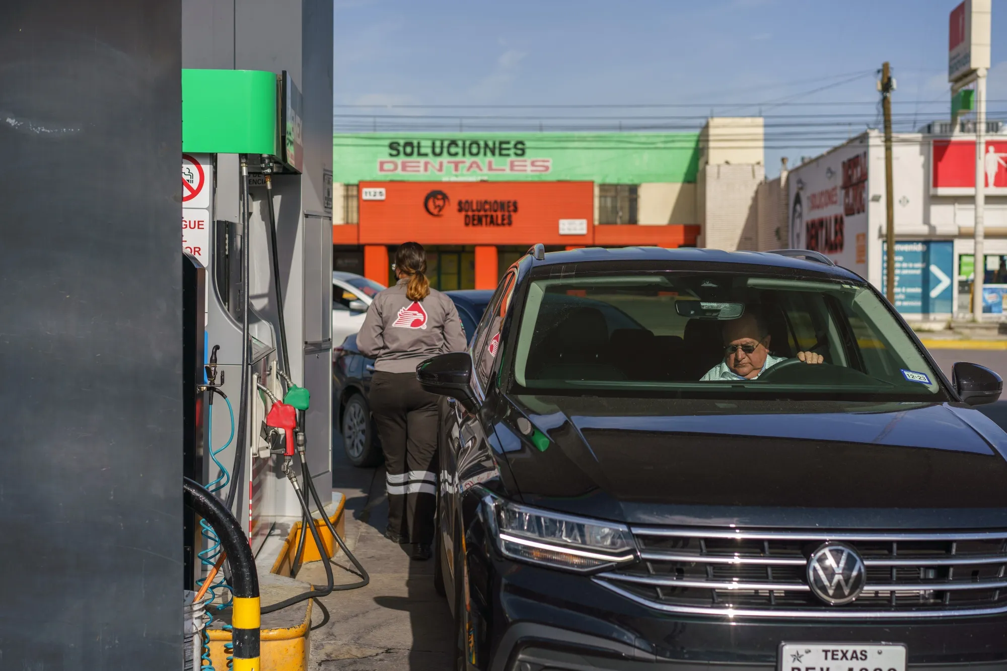 A driver with Texas license plates refuels at a Pemex gas station in Ciudad Jurez.