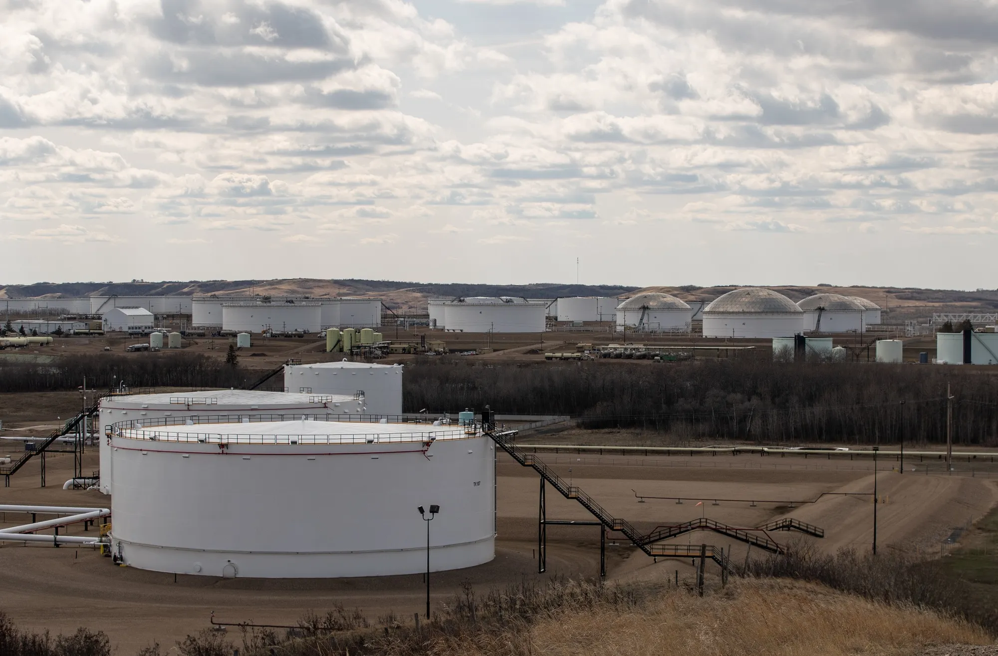 Oil storage tanks and pipelines at an oil terminal in Hardisty, Alberta.