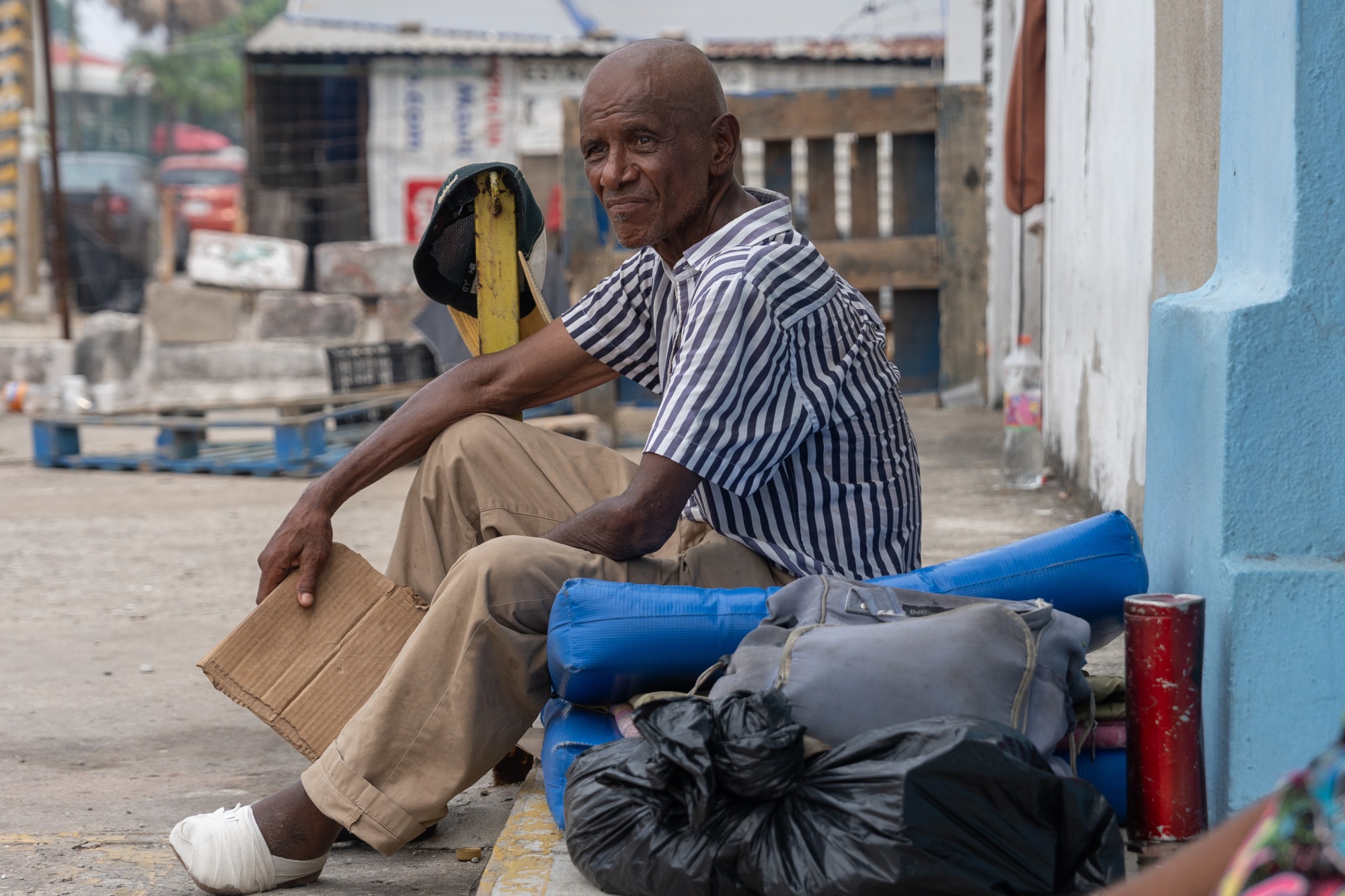 Lorenzo Sánchez Rojas, born in Cuba and 65 years old, sits outside an abandoned store where he sleeps in Villahermosa, Tabasco state, Mexico, on May 24th, 2026.