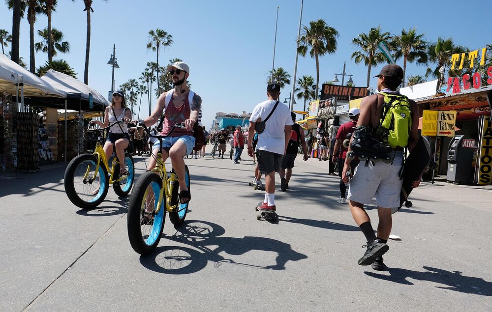 Cyclists ride along the Venice Beach boardwalk on May 25.