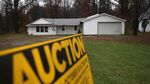 An auction sign stands in front of a foreclosed house on Oct. 29, 2012, in Warren, Ohio.
