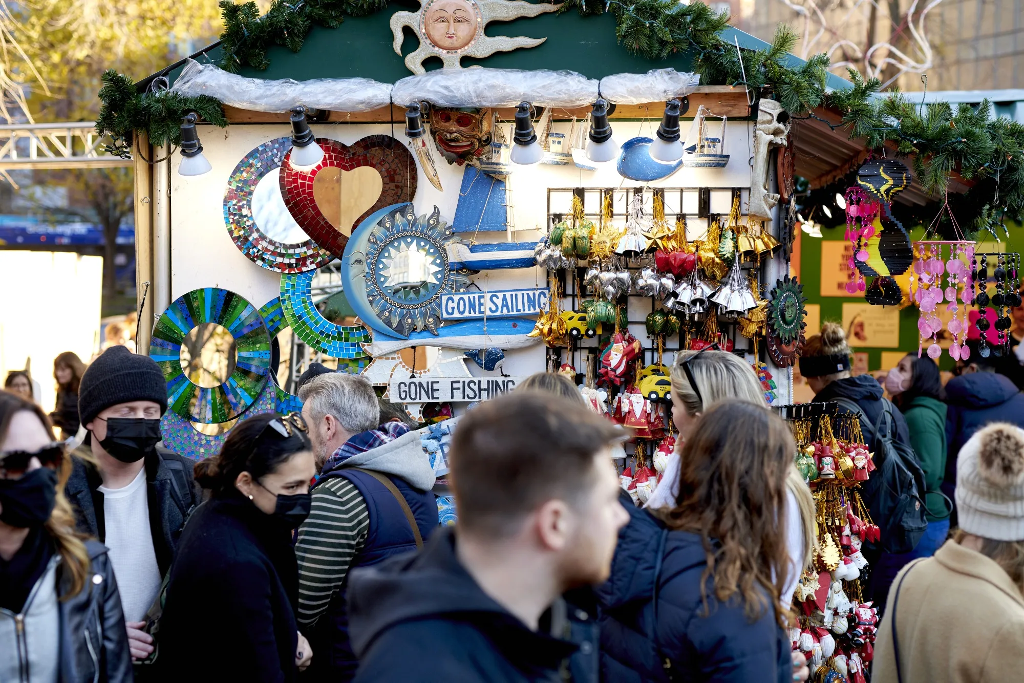 Shoppers walk through the Urbanspace Union Square Holiday Market in New York, U.S., on Sunday, Dec. 12, 2021. The U.S. Census Bureau is scheduled to release retail sales figures on December 15.