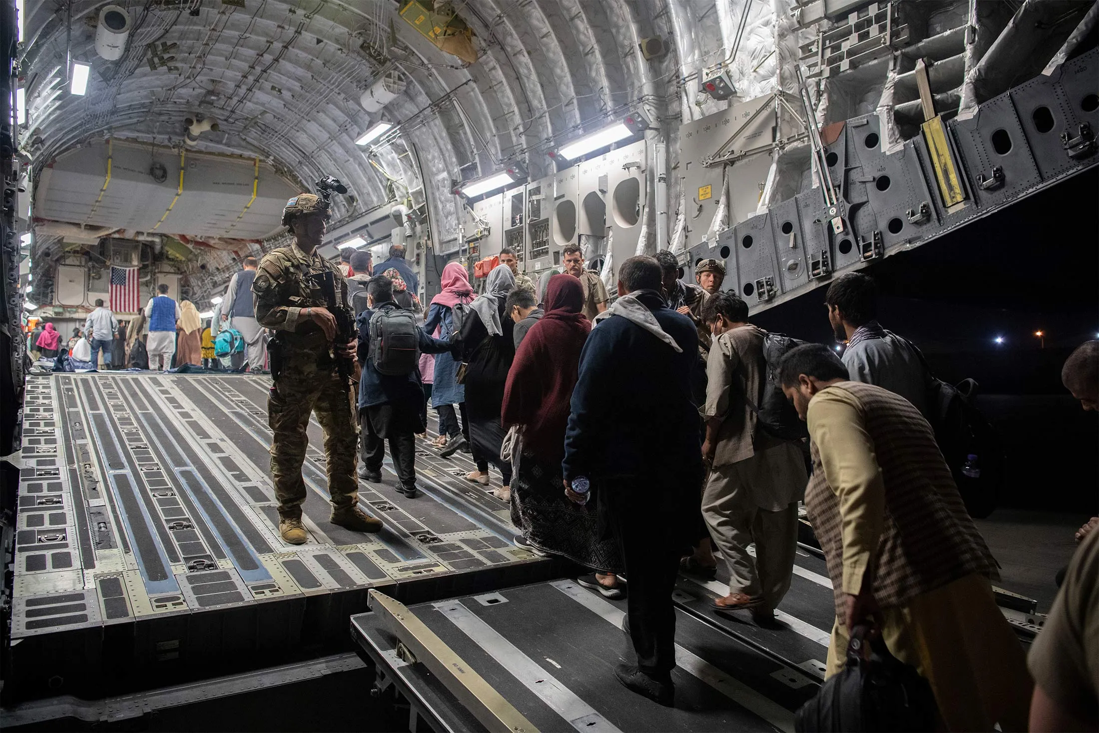 Afghan passengers board a U.S. Air Force C-17 Globemaster III at Hamid Karzai International Airport in Kabul, on Aug. 22.&nbsp;