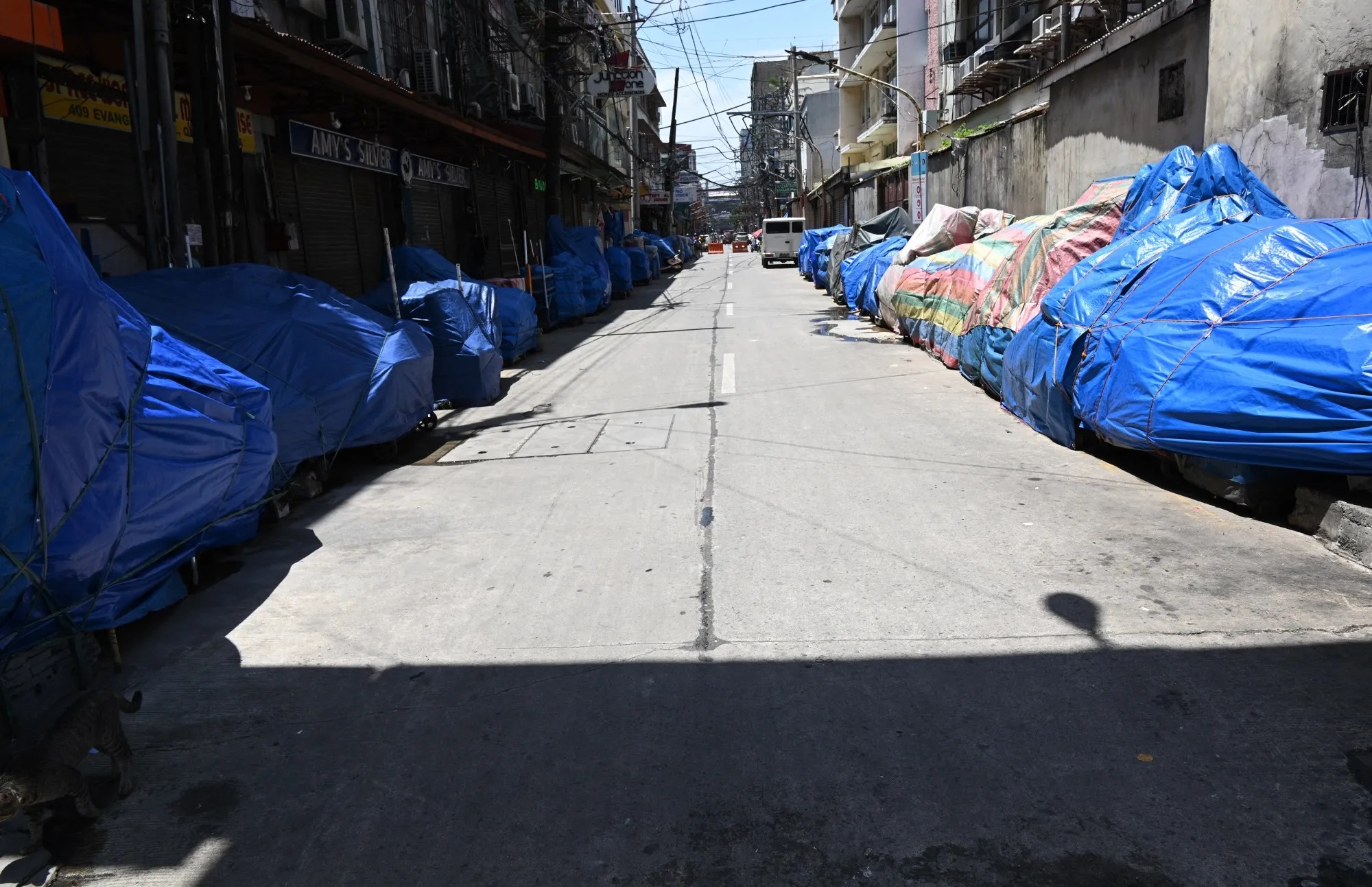 Covered rolling carts with goods for sale&nbsp;on the side of an empty street near in Manila on Aug. 6.
