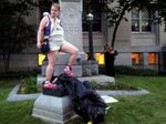 Claire Meddock, 21, stands on a toppled Confederate statue on Monday, Aug. 14, 2017, in Durham, N.C.