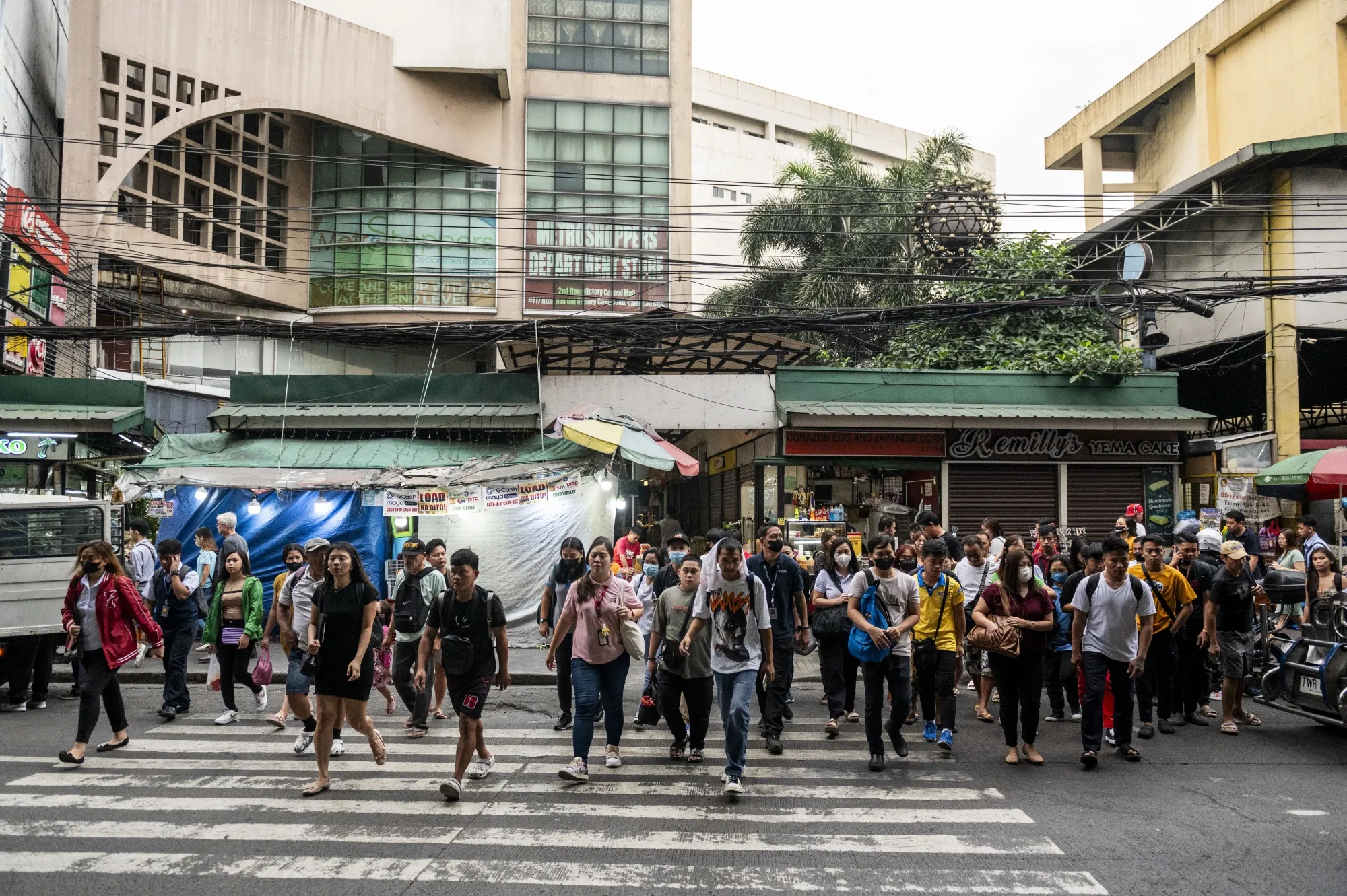 Pedestrians cross a road in Caloocan City, Philippines.