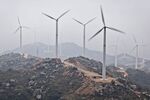China Resources New Energy Group Co. Ltd. wind turbines spin in Shantou, Guangdong province, China, on Friday, Jan. 21, 2011. China Resources Power Holdings Co., the Hong Kong-listed mainland electricity producer, said it may spend 4.8 billion to 6.4 billion yuan ($970 million) adding 800 megawatts of wind power capacity every year.
