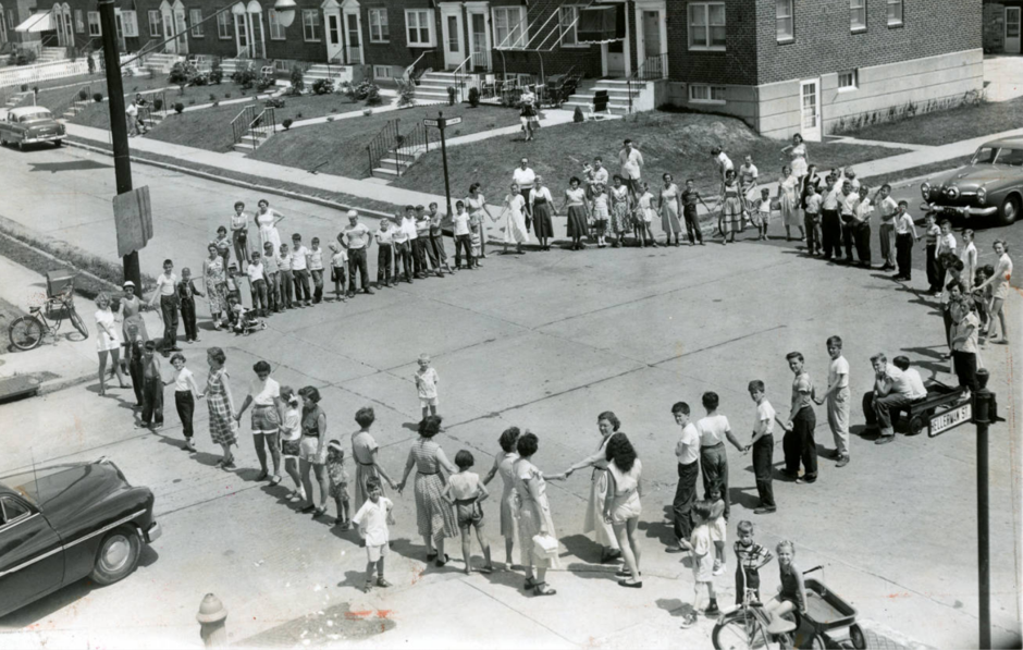 Residents block a Philadelphia intersection on a July weekend in 1953. Stop signs were installed the following Monday.