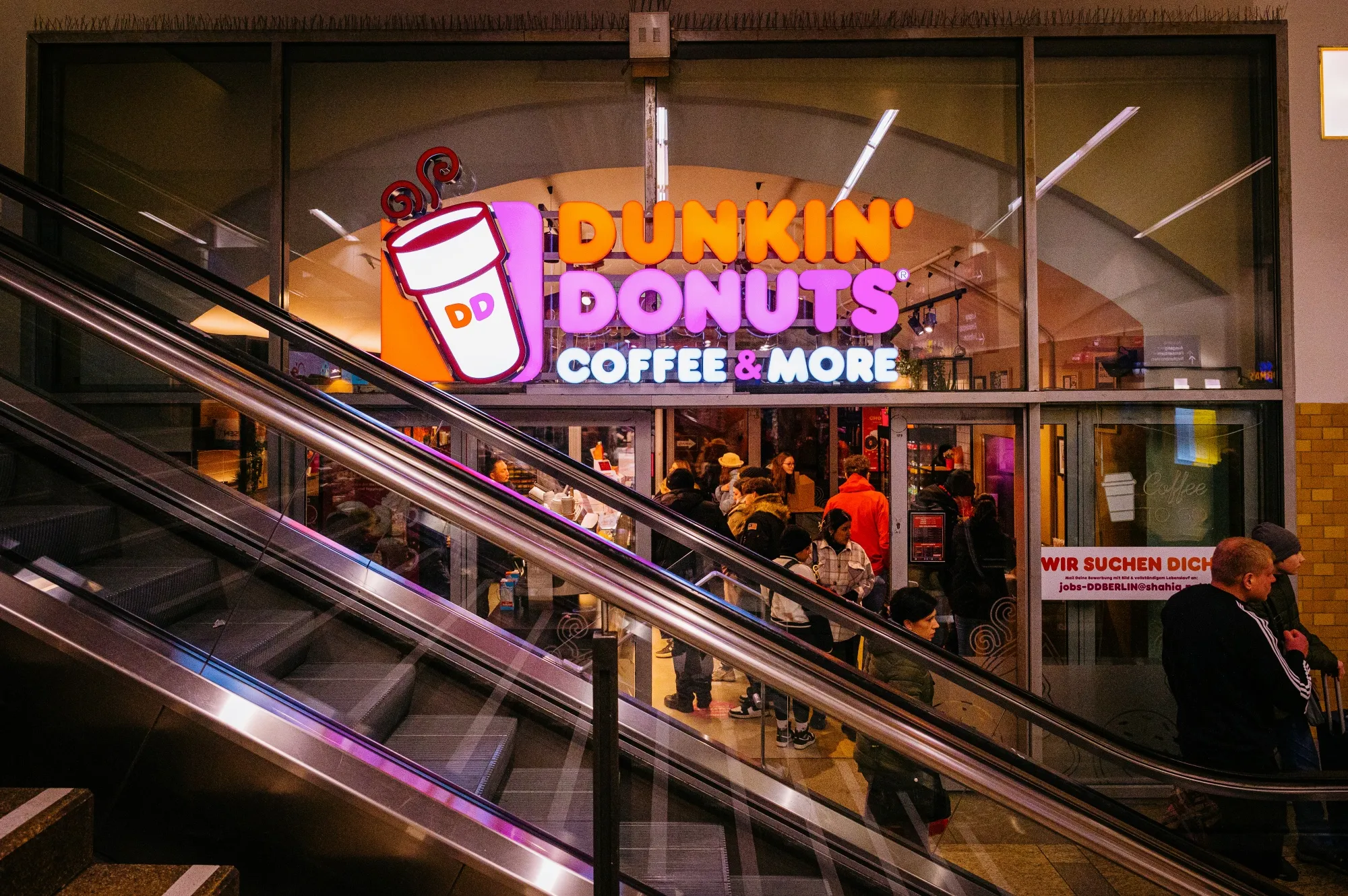 Customers queue at a Dunkin' Donuts Inc. store.