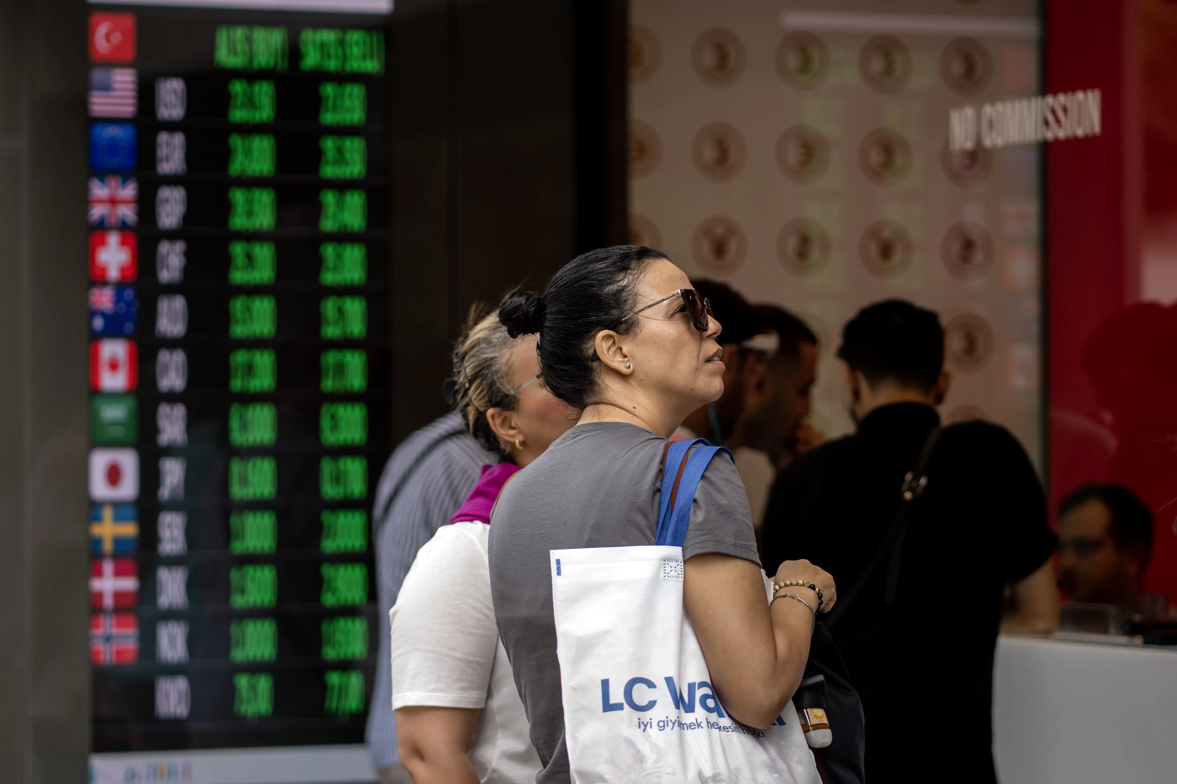 Customers at a currency exchange bureau in Istanbul.&nbsp;