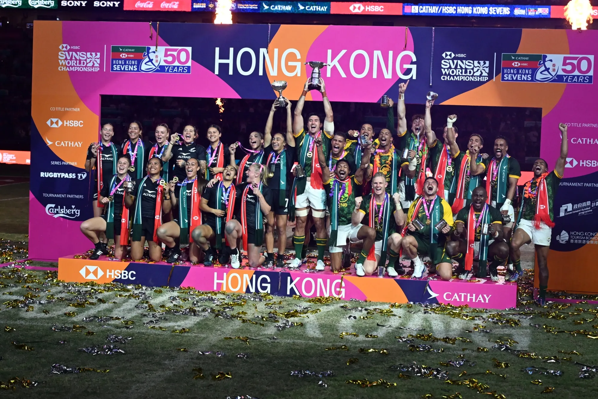 The New Zealand women and South Africa men teams celebrate winning their finals.