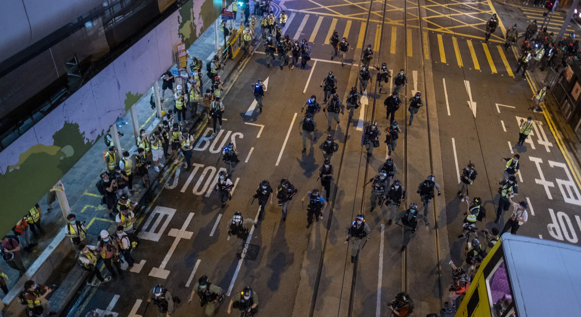Riot police charge in an attempt to disperse demonstrators on Des Voeux Road&nbsp;during a protest in the Central district of Hong Kong on June 9.
