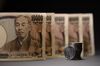 Japanese 100 yen coins and 10,000 yen banknotes are arranged for a photograph in Kawasaki, Kanagawa Prefecture, Japan, on Saturday, July 7, 2018.