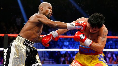 Floyd Mayweather Jr. throws a right at Manny Pacquiao during their welterweight unification championship bout on May 2, 2015, at MGM Grand Garden Arena in Las Vegas.