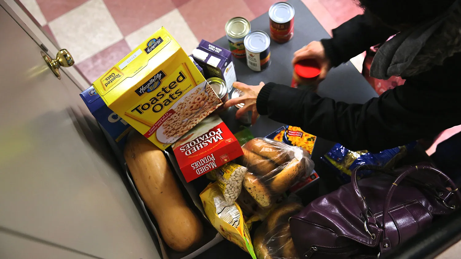 People receive free groceries at a food pantry run by the Food Bank for New York City on Dec. 11, 2013.
