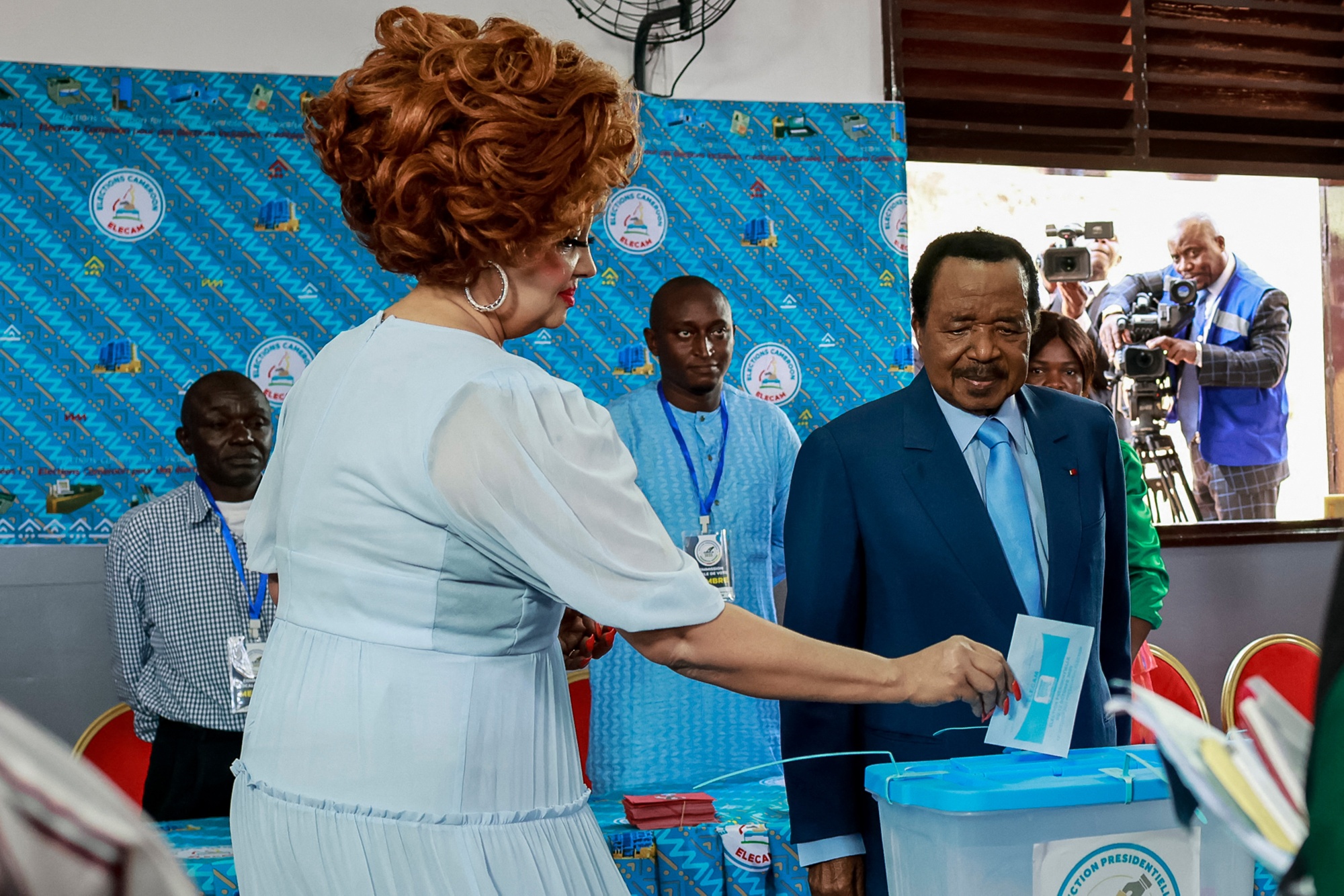 Paul Biya, right, watches his wife cast her ballot at a polling station in Yaounde on Oct. 12. Photographer: Daniel Beloumoui Olomo&#x2F;AFP&#x2F;Getty Images