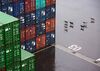 A pack of dogs walk past shipping containers at the Kao Ming Container Terminal Corp. (KMCT) terminal at the Port of Kaohsiung in Kaohsiung, Taiwan, on Tuesday, May 24, 2016.