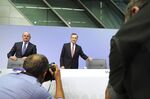 Mario Draghi, right, arrives for a rates decision news conference in Frankfurt on Sept. 12, 2019.
