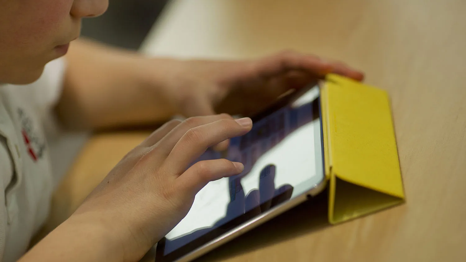 A child learns how to build a video game using code on an Apple Inc. iPad Mini during the Hour of Code workshop at an Apple store in New York on Dec. 10, 2015.
