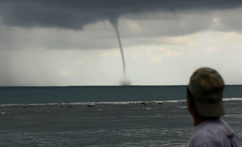 A man observes twin waterspouts in northern Indonesia in 2009.