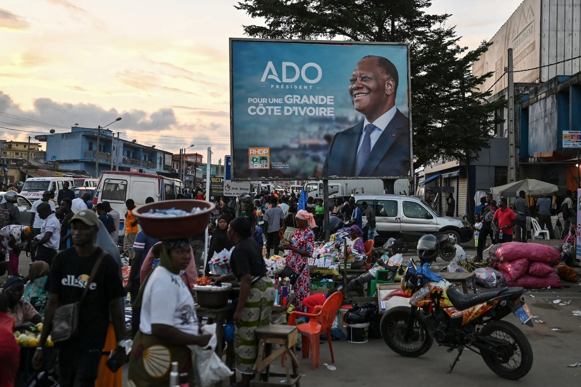 A campaign billboard for Ivory Coast President Alassane Ouattara at a market in Abidjan.