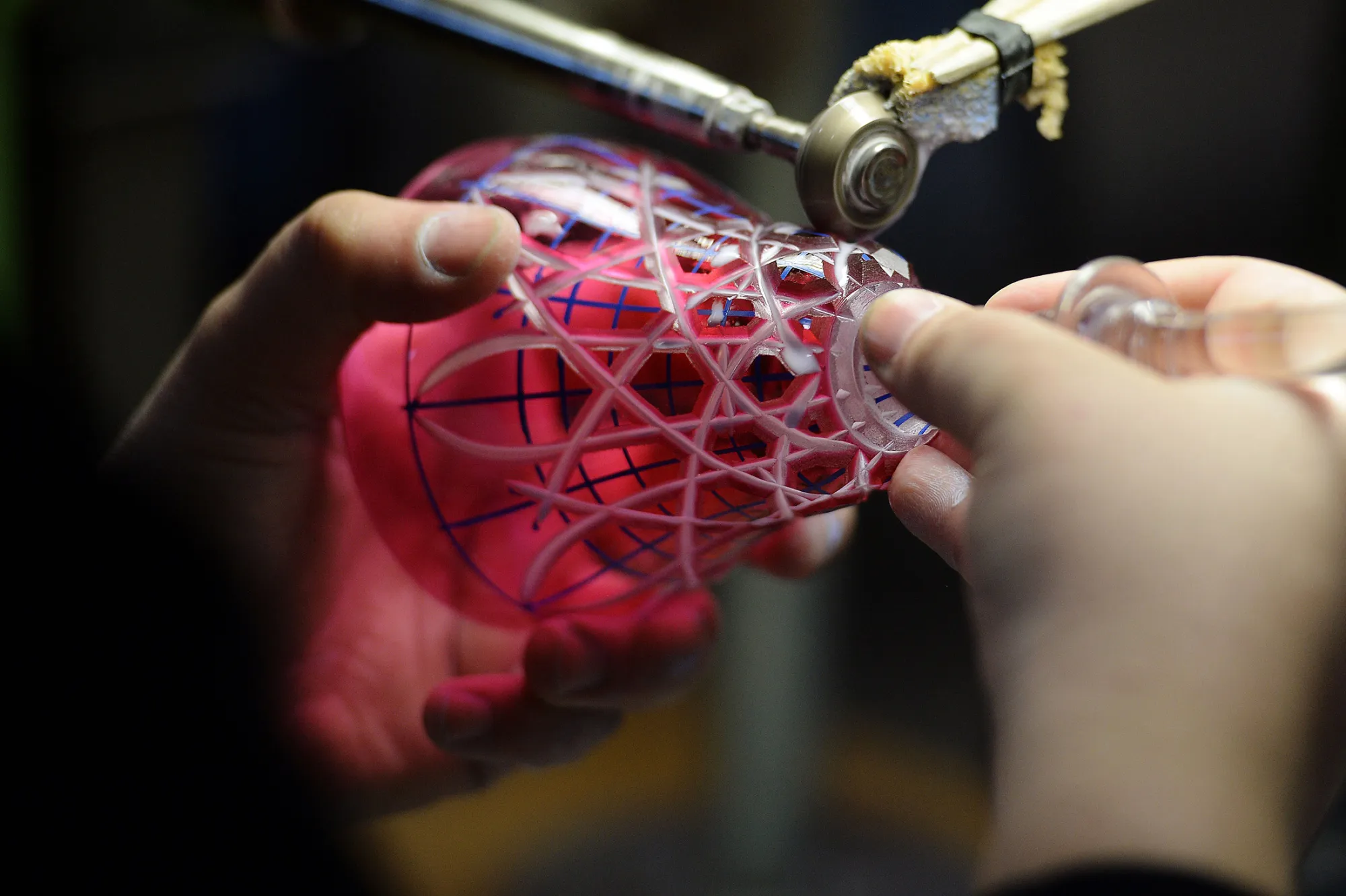 A glassblower shapes a stemmed glass at crystal glass maker Baccarat.
