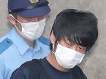 Tetsuya Yamagami is escorted at a police station, in Nara Nishi, Japan, on July 10.