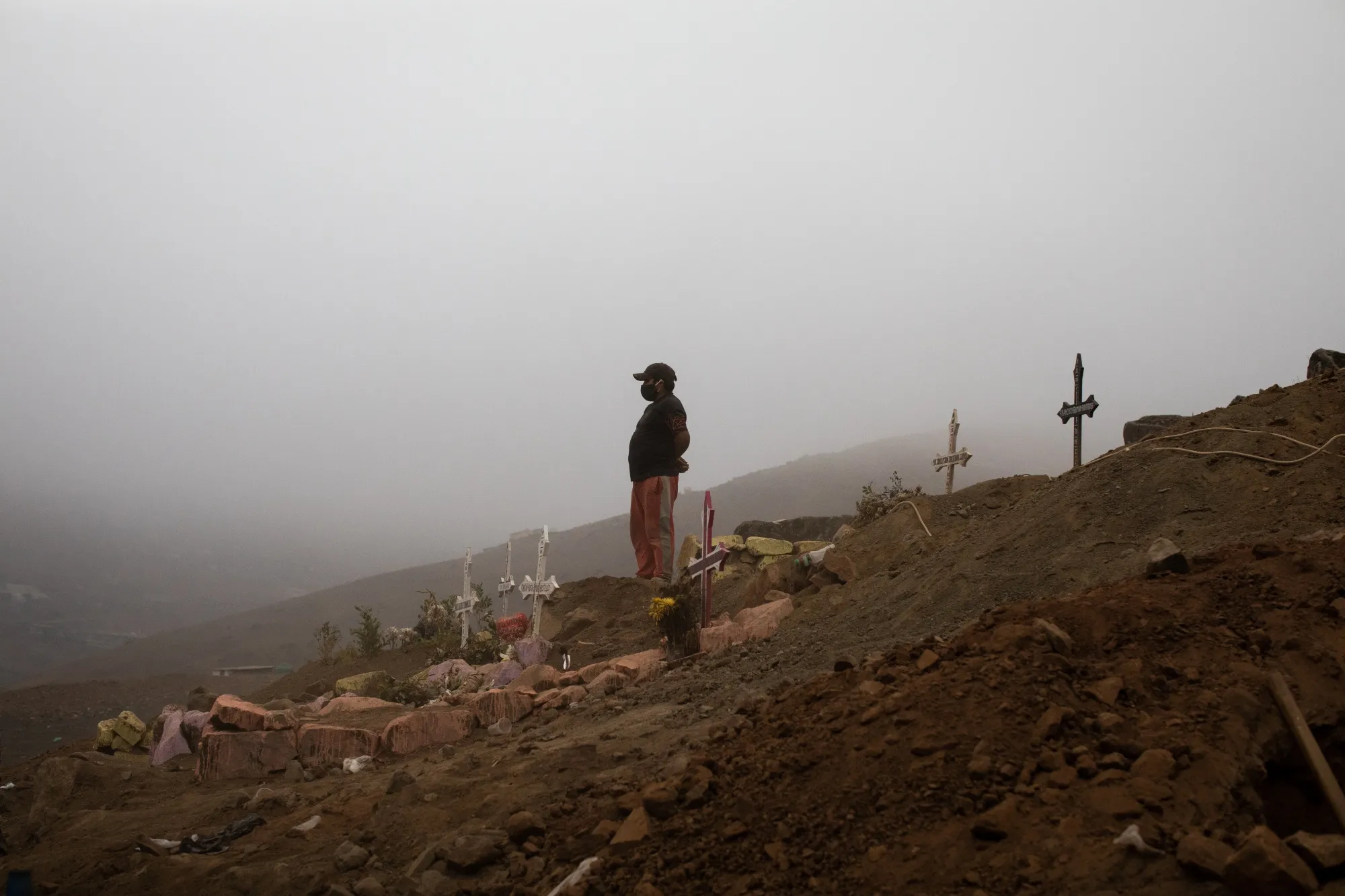 A cemetery worker wears a protective mask at the Nueva Esperanza cemetery in Lima, Peru, on&nbsp;June 17, 2020.&nbsp;