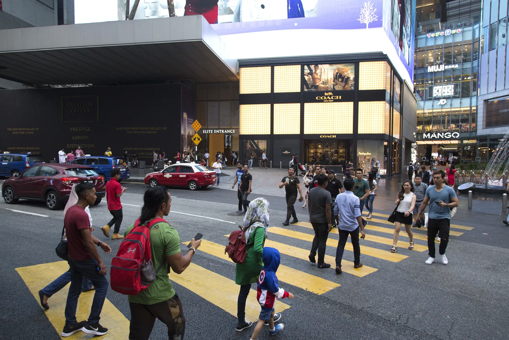 Pedestrians cross a street in Kuala Lumpur.