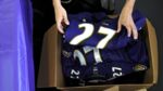 An authenticator puts the jersey of of former running back Ray Rice #27 of the Baltimore Ravens into a box after a football fan stood in line to exchange the jersey at M&T Bank Stadium on September 19, 2014 in Baltimore, Maryland. Following a video that surfaced of Ray Rice knocking his then fiancee Janay Rice unconscious in an New Jersey Casino elevator, the Baltimore Ravens cut Rice and the NFL suspended him indefinitely. The Baltimore Ravens offered fans an option for a free exchange of their Ray Rice uniforms for another Ravens player.