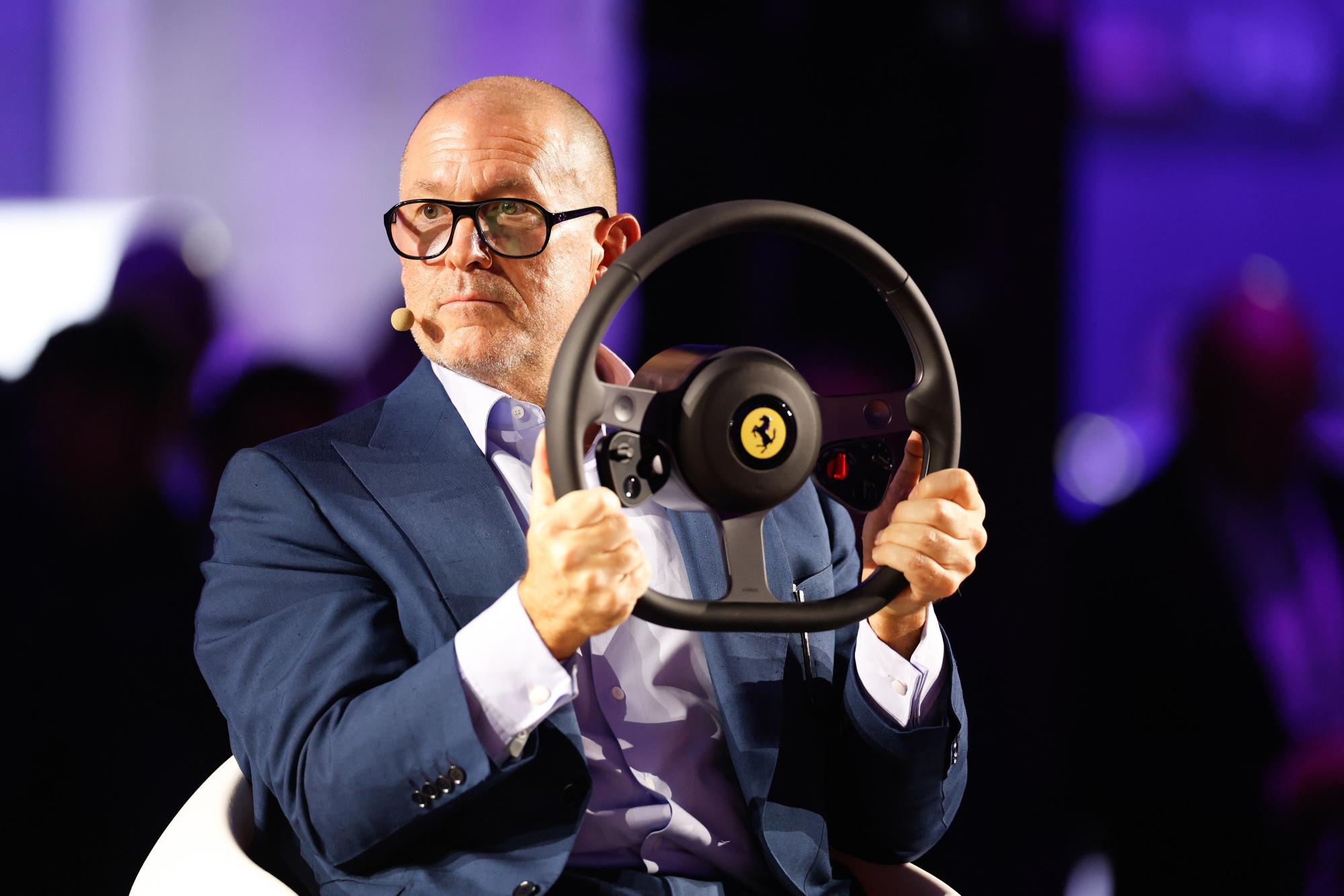Jony Ive with the steering wheel of a Ferrari Luce electric vehicle at the Wave by Vento tech conference in Turin, Italy, on Wednesday, Oct. 7, 2026. Photographer: Giuliano Berti/Bloomberg