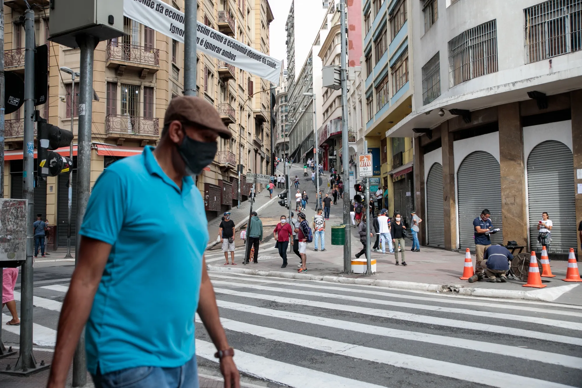 People wearing protective masks walk through downtown Sao Paulo, Brazil, on&nbsp;June 10.