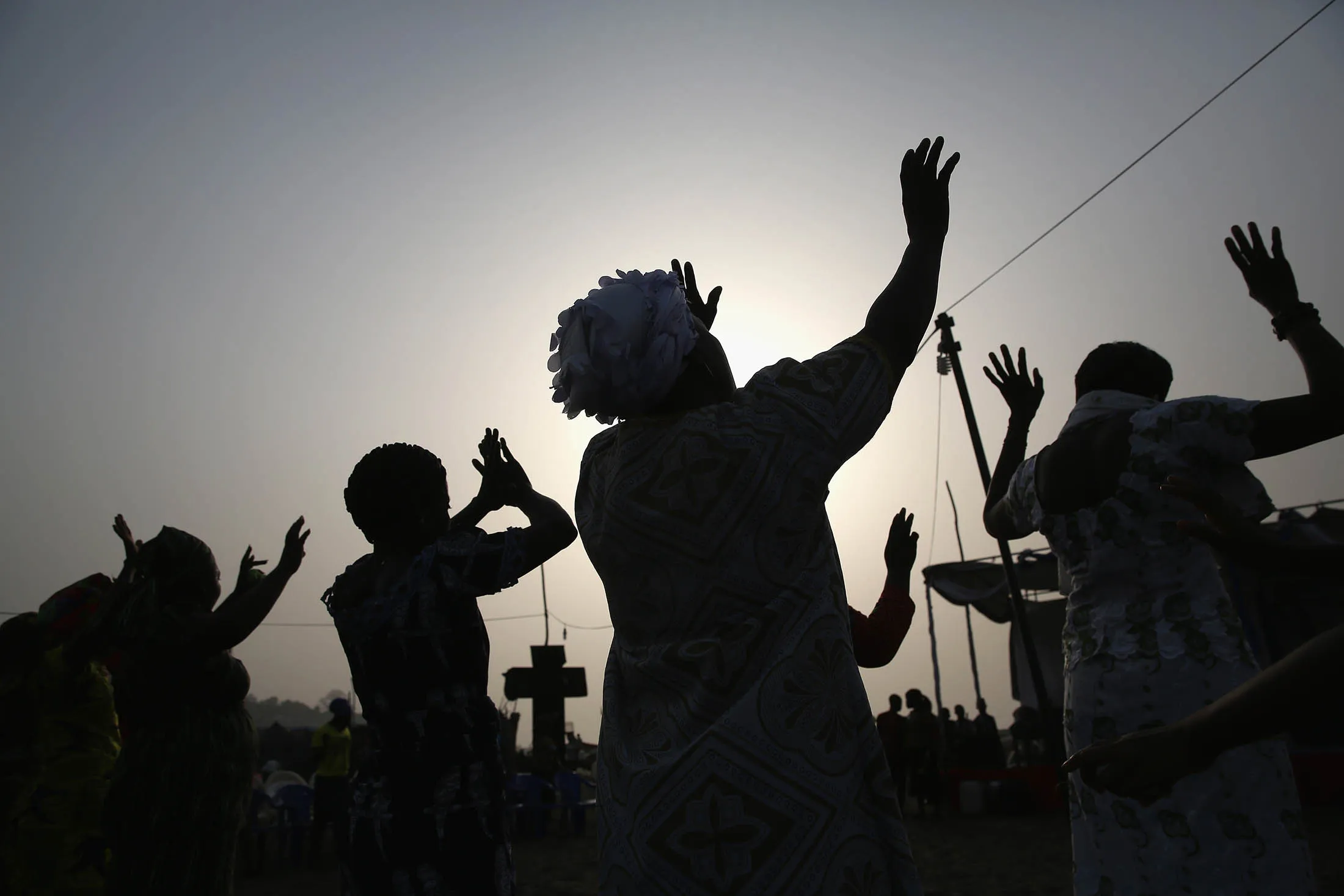 MONROVIA, LIBERIA - FEBRUARY 09: People pray during a seaside church service in the West Point slum in Liberia in February 2016.
