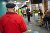 Visitors sit in the waiting area before receiving a vaccine in Oldham, U.K.