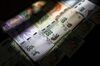 Argentine 100, 200, 500 and 1000 peso banknotes are arranged for a photograph in Buenos Aires, Argentina, on Saturday, March 30, 2019. Argentina's central bank has taken enough steps in the past month to prevent the recent slump in the peso turning into a repeat of last year's rout, according to strategists and traders.