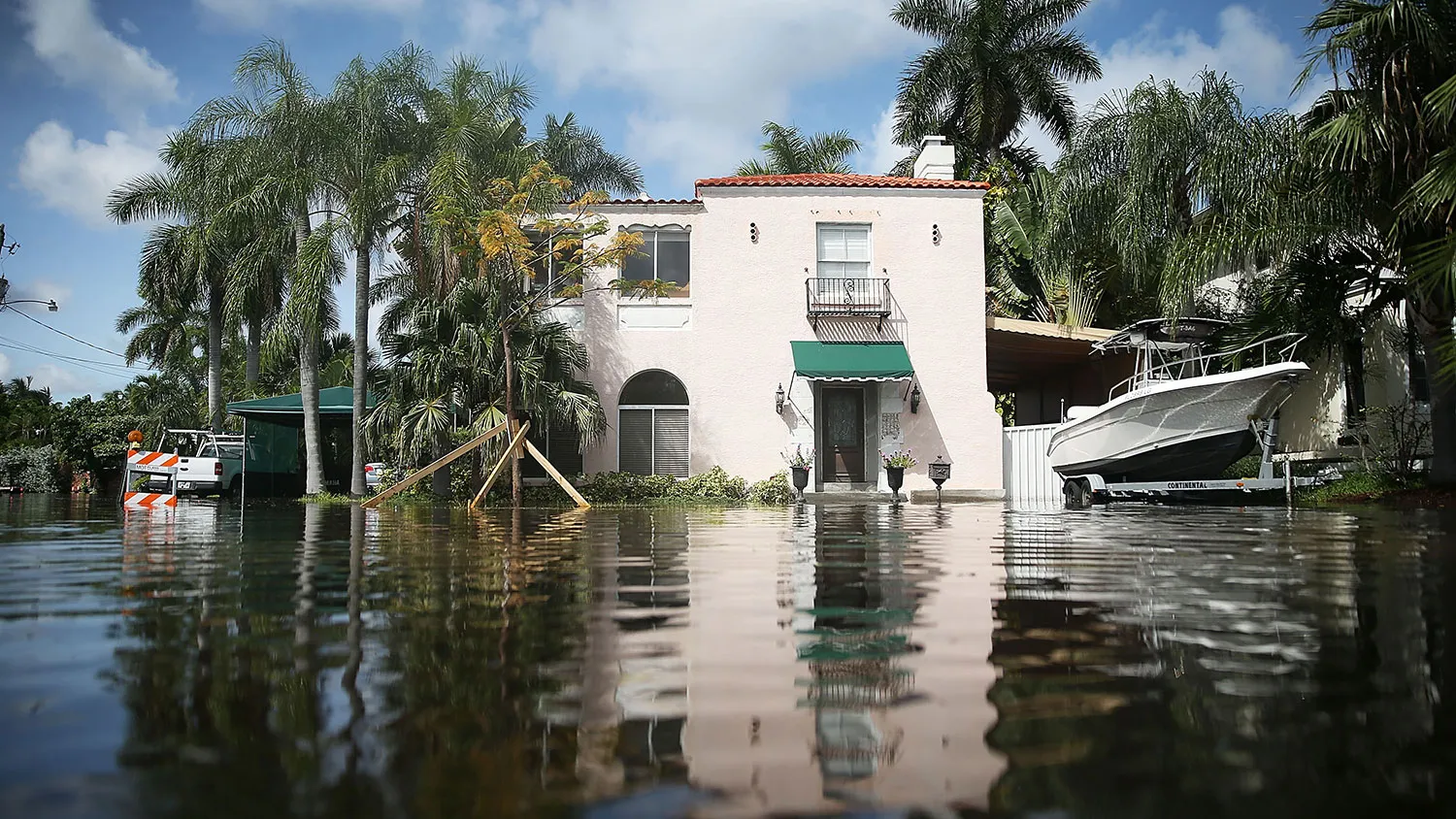 A home is seen surrounded by flood water caused by the combination of the lunar orbit, which caused seasonal high tides, and what many believe are rising sea levels due to climate change on Sept. 30, 2015, in Fort Lauderdale, Florida.

