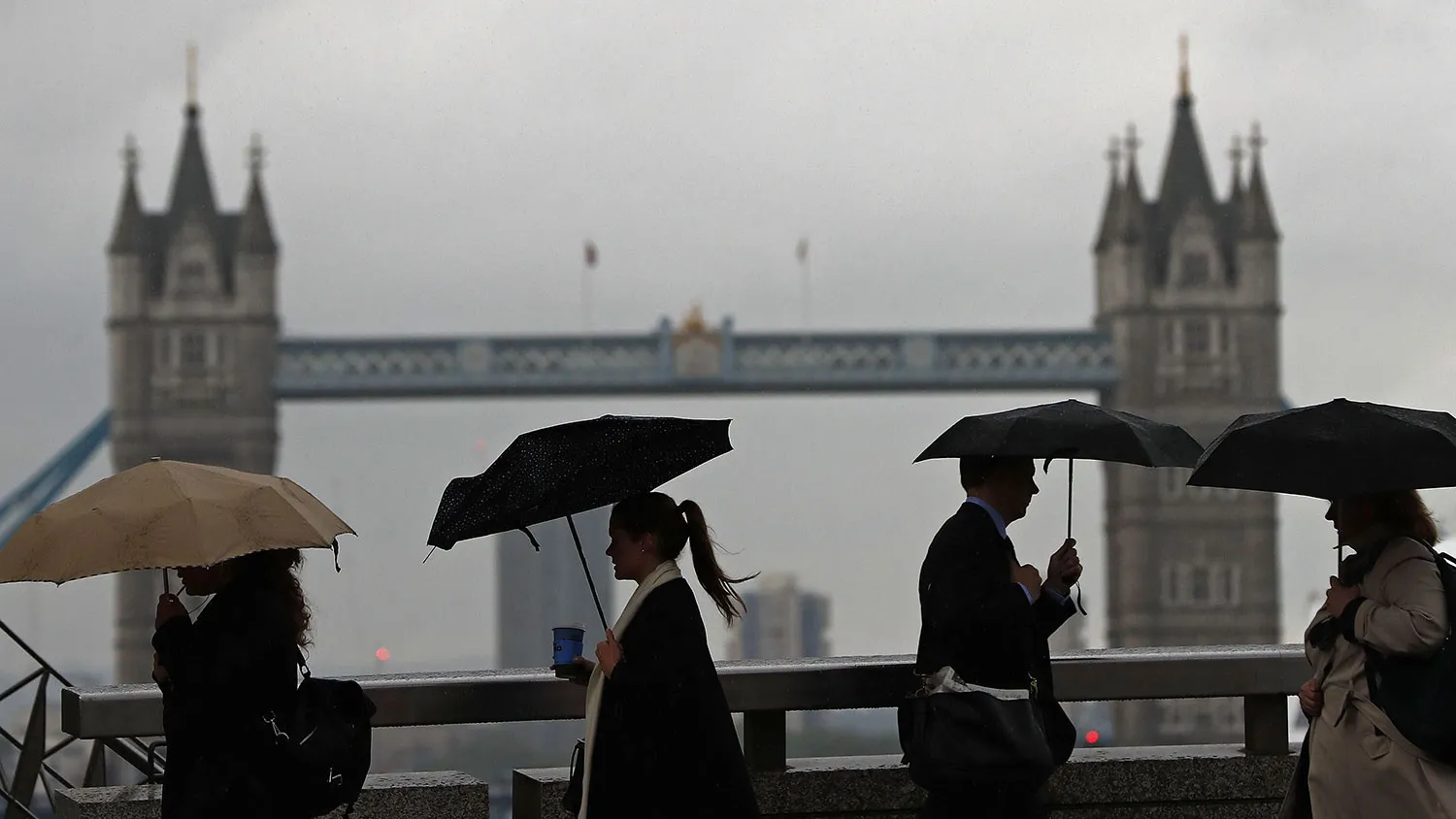Commuters walk across London Bridge on June 27, 2016.
