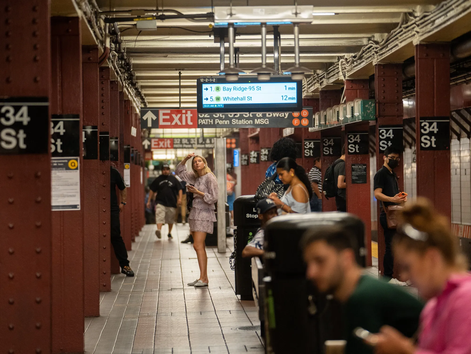 Commuters wait on the platform of a subway station in New York.