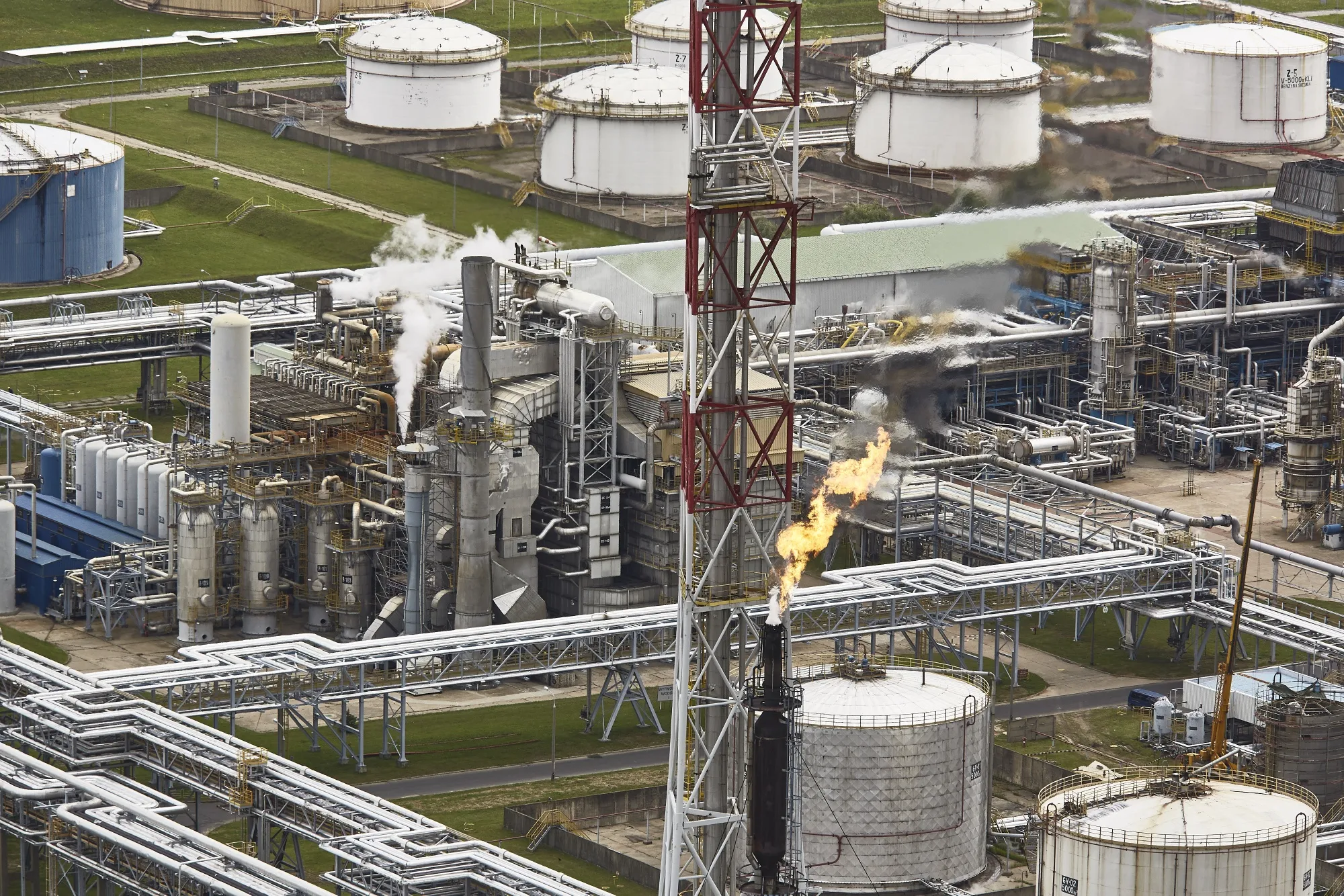 A flame rises from a flare stack at the PKN Orlen SA oil refinery in Plock, Poland.