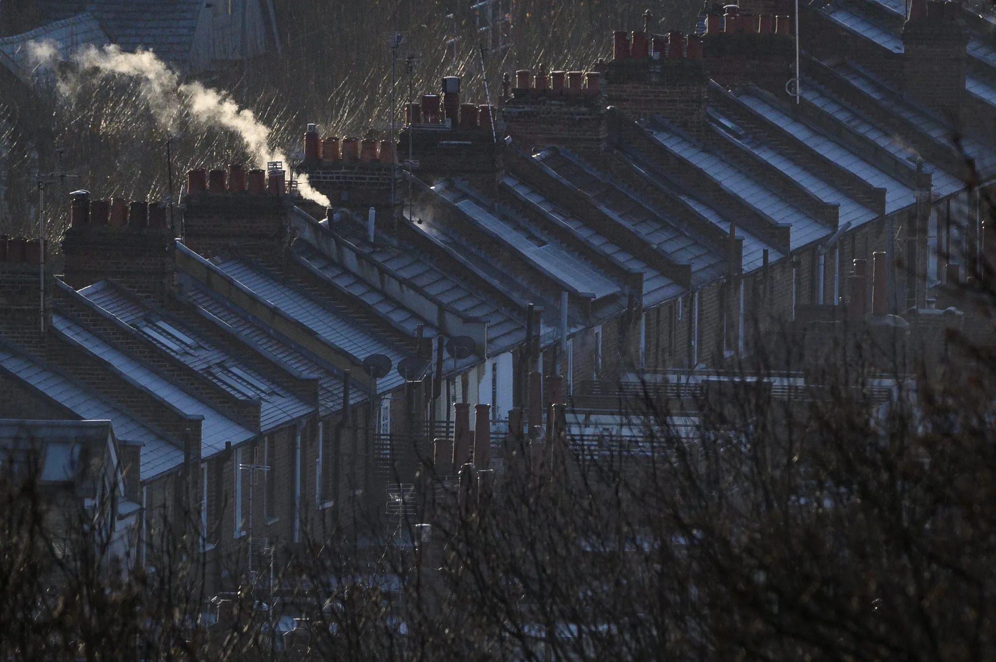 Smoke and steam rise from houses in London in January 2022.