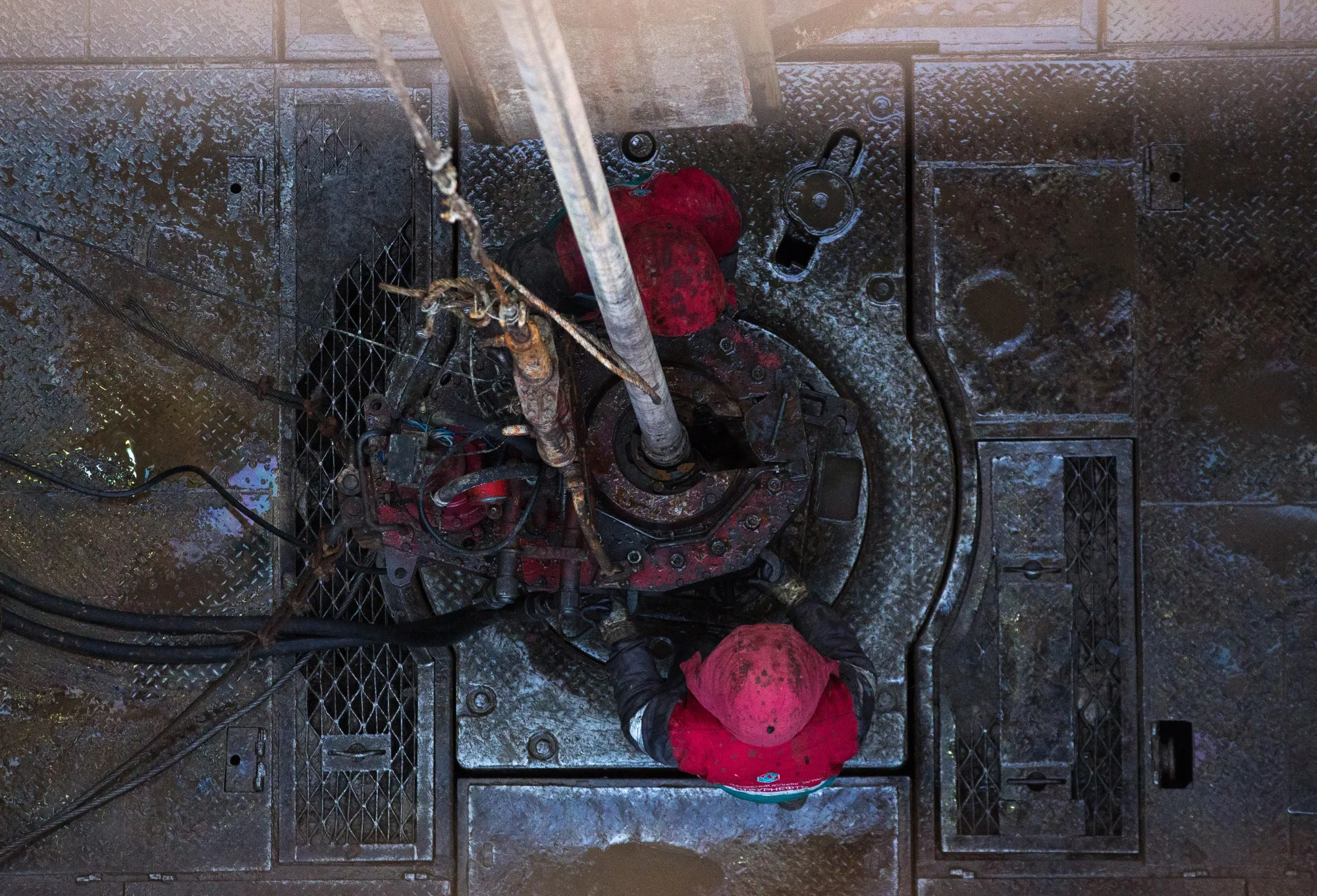 Oil workers position drilling pipes at the rotary table on a drilling rig, operated by Tatneft PJSC, on an oilfield near Almetyevsk, Tatarstan, Russia, on Tuesday, March 6, 2019. Tatneft explores for, produces, refines, and markets crude oil.