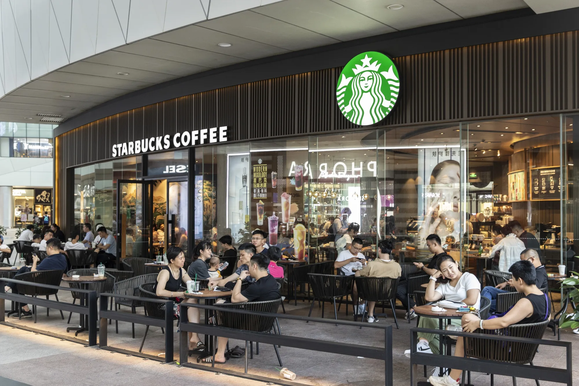 Customers&nbsp;outside a Starbucks Corp. coffee shop in Xiamen, China.
