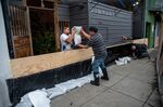 Workers build a flood protection barrier at the entrance to a business in the Mission District of San Francisco.&nbsp;