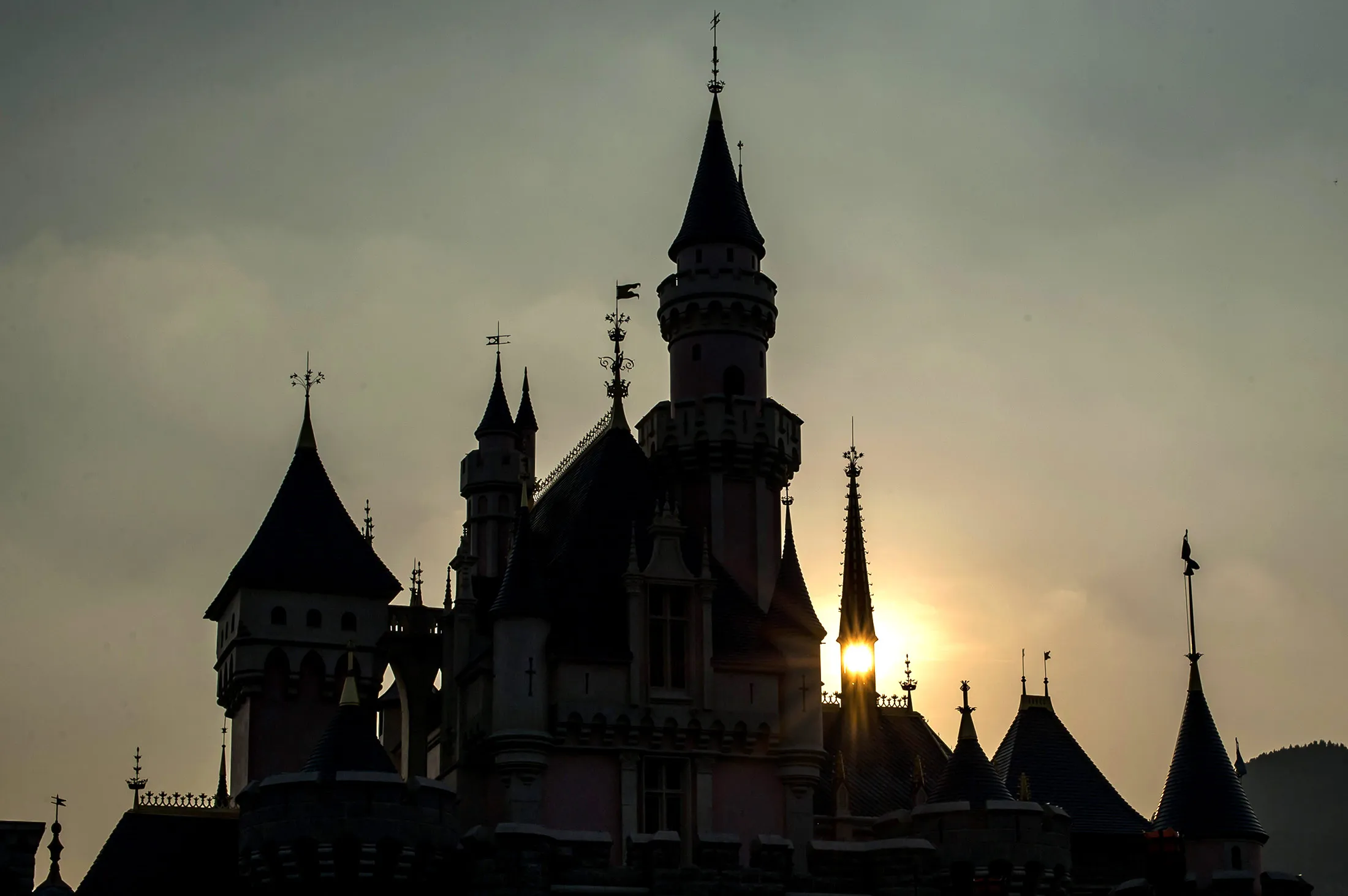 The sun sets behind the Sleeping Beauty Castle at Walt Disney Co.'s Disneyland Resort in Hong Kong.

