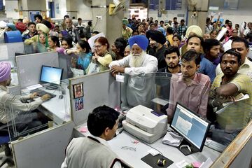 Queueing up to deposit and exchange discontinued currency at a bank on Nov. 17