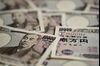 Japanese 10,000 yen banknotes are arranged for a photograph in Kawasaki, Kanagawa Prefecture, Japan, on Tuesday, July 9, 2013. Economists are ditching forecasts for the Bank of Japan to further expand its record easing this year amid signs that a recovering economy may spur inflation.