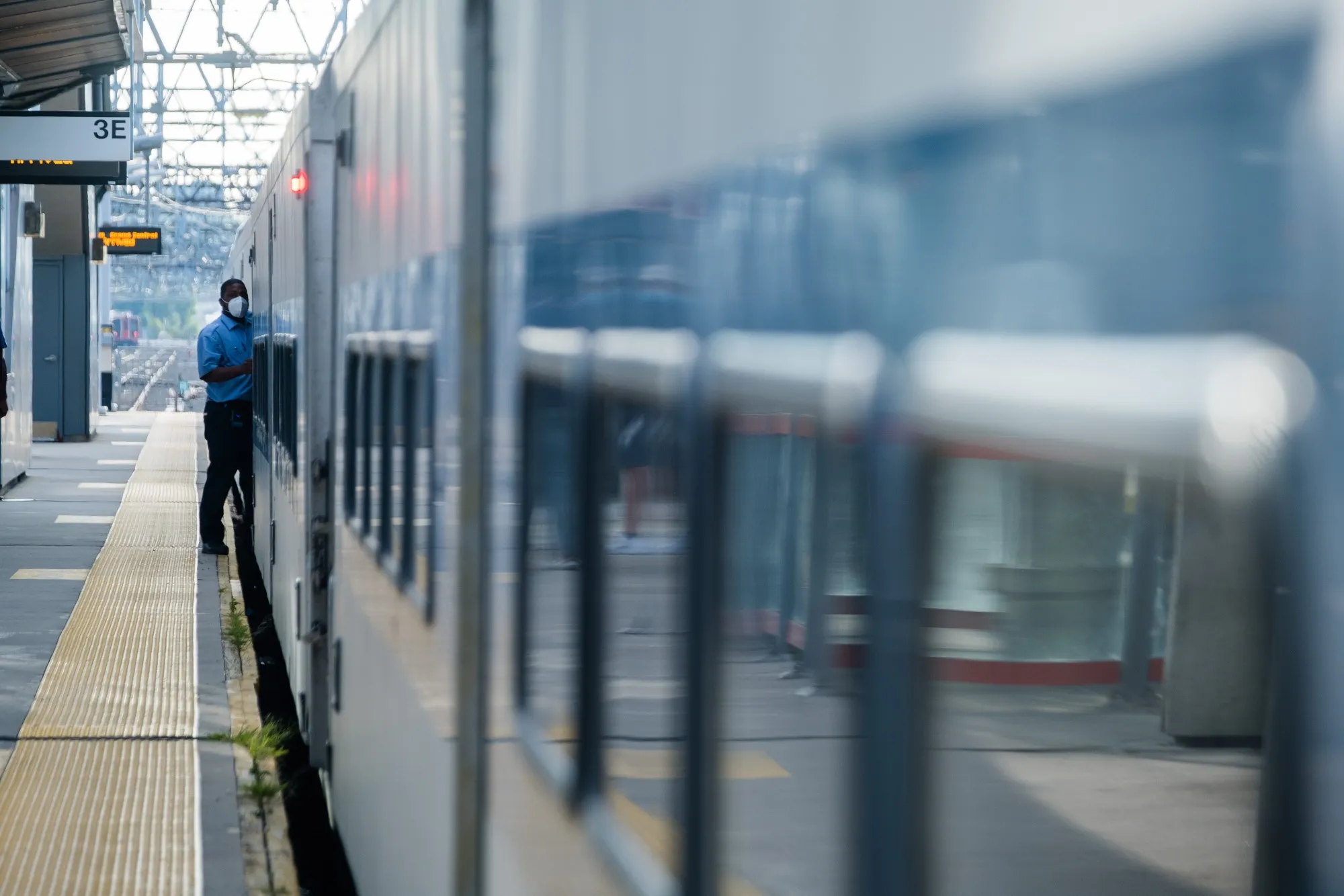 A conductor&nbsp;boards a train at the Metro-North station in Stamford, Connecticut.