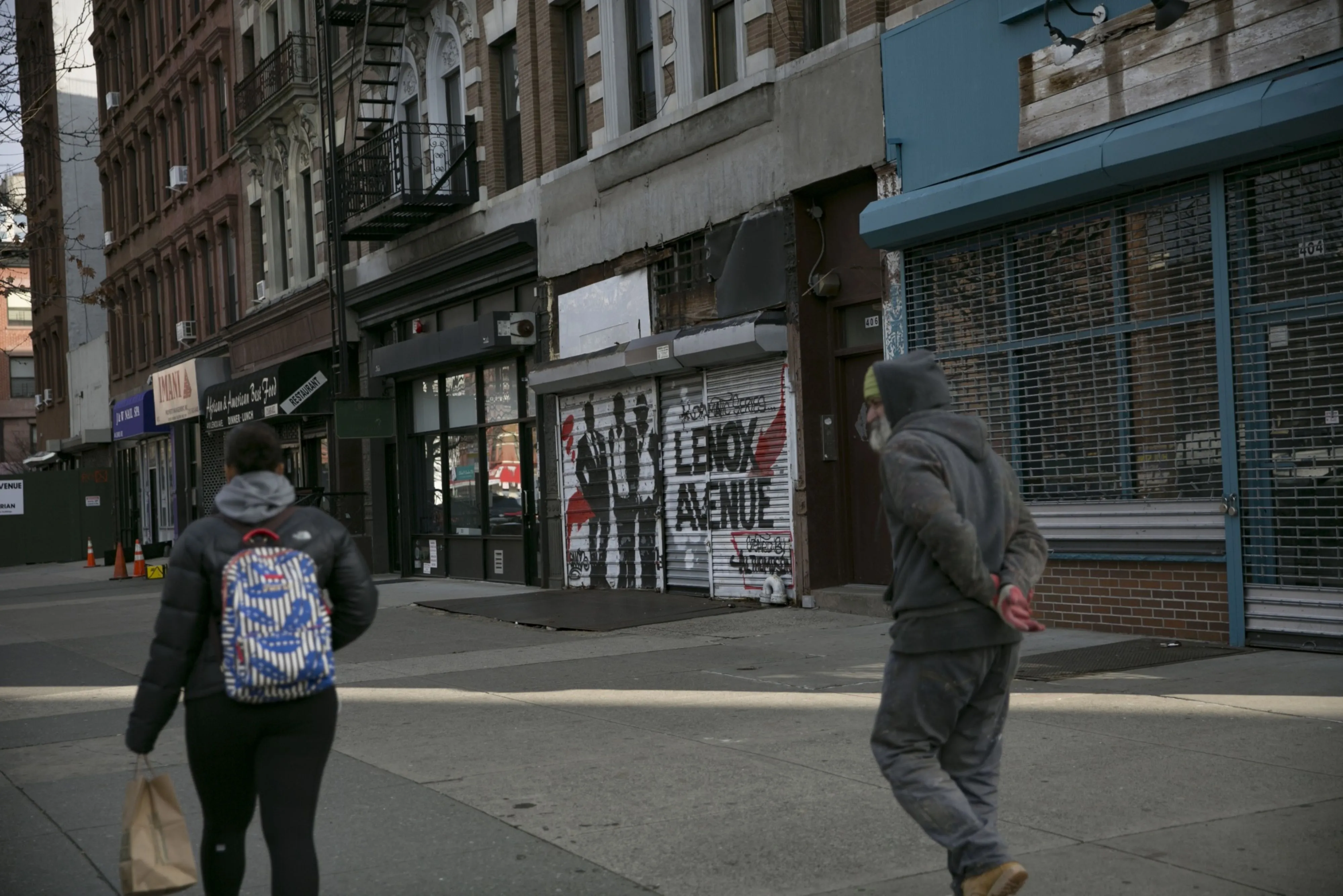 Pedestrians walk past a vacant storefront in the East Harlem neighborhood of New York in December 2018.&nbsp;