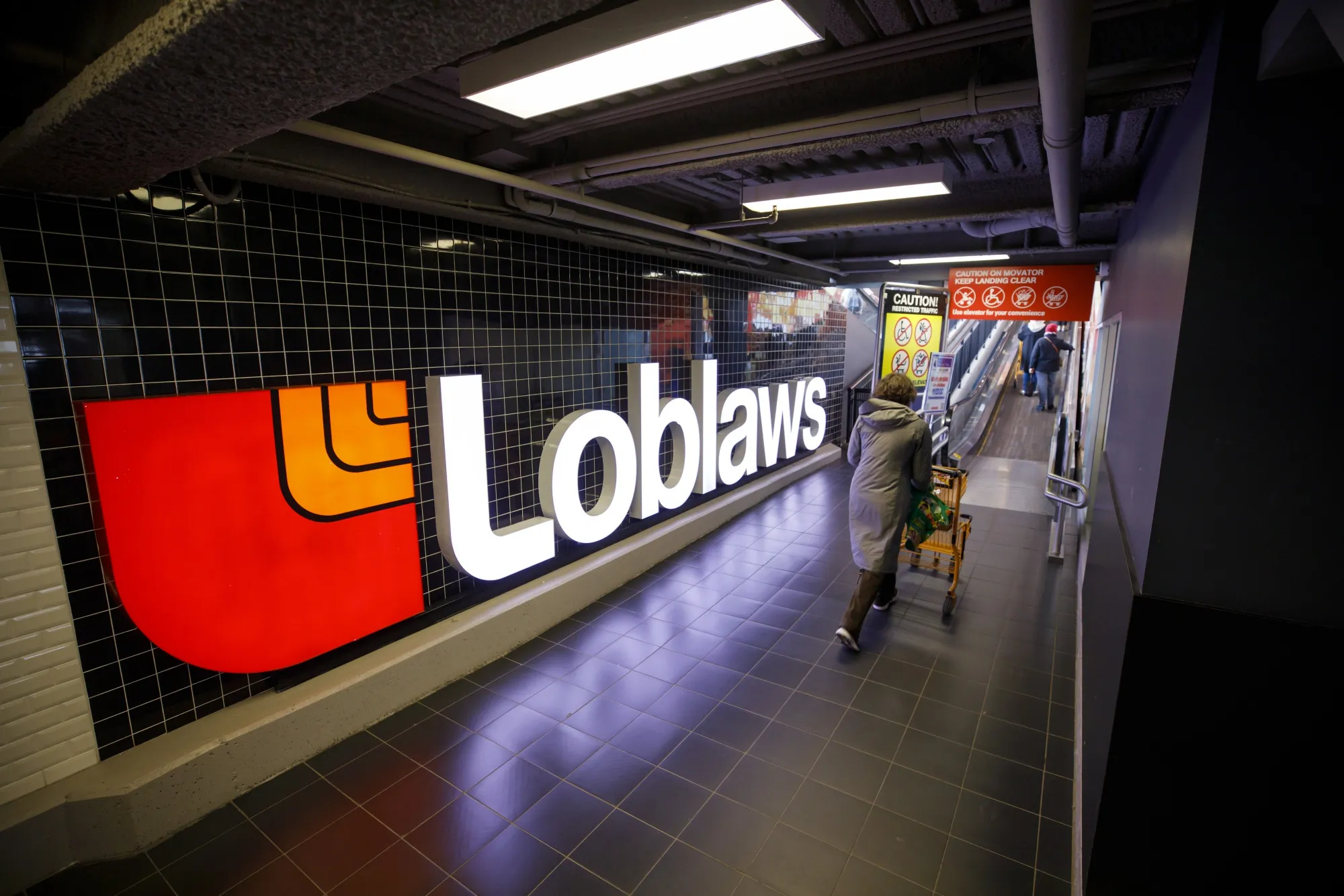 A shopper enters a Loblaw grocery store in Toronto.